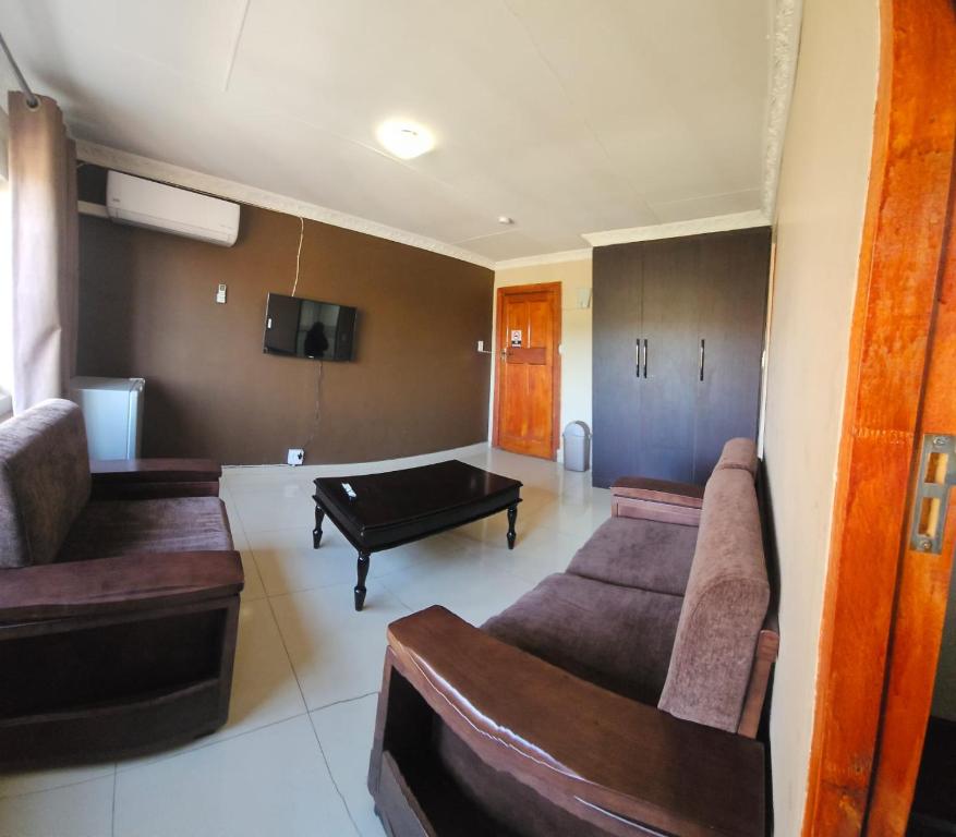 a living room with couches and a pool table at DeRockview Lodge in Johannesburg