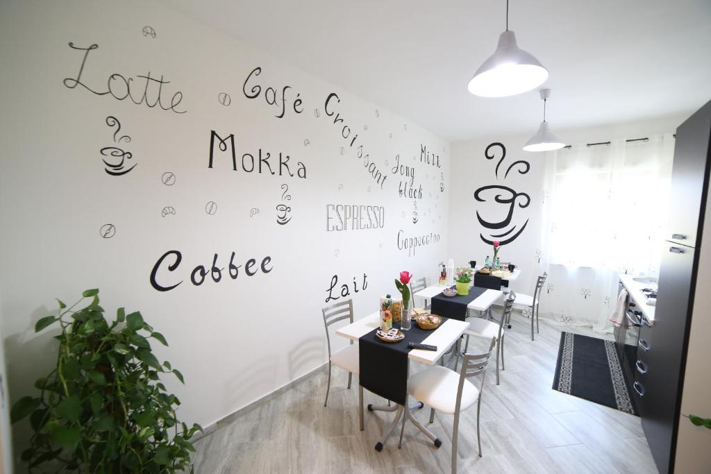 a room with tables and chairs with writing on the wall at Parco Carrara in Crotone