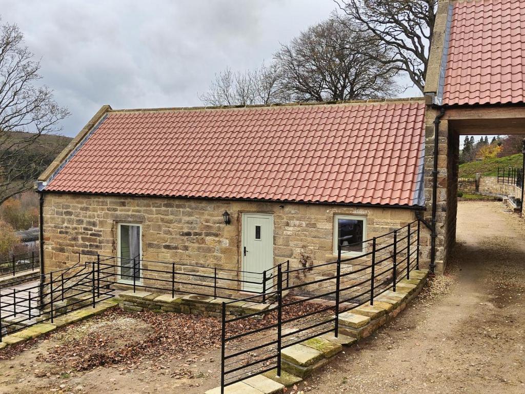 a small brick building with a red roof at 2 Bed in Castleton oc-p34012 in Castleton