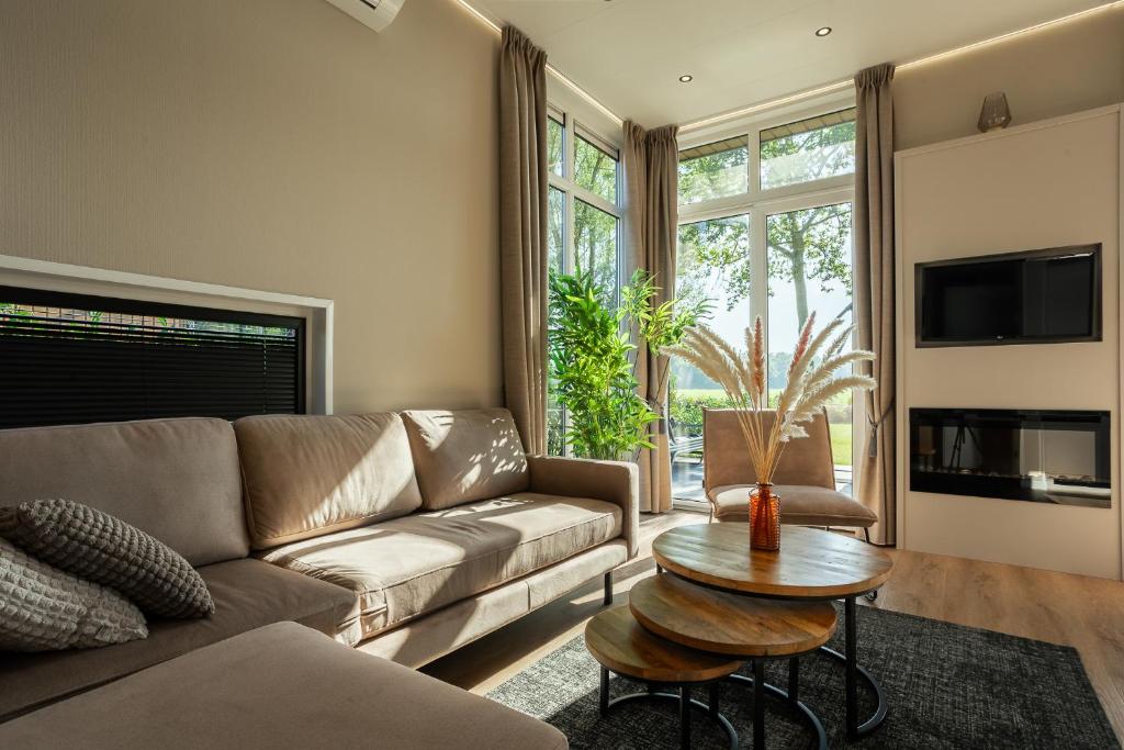 a living room with a couch and a table at Mondri in Winterswijk