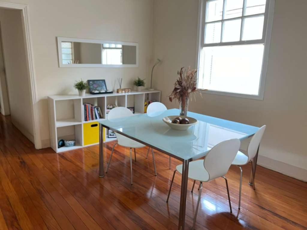 a dining room table with white chairs and a table at Casa Matias in Socorro