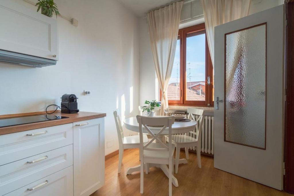 kuchnia i jadalnia ze stołem i krzesłami w obiekcie La Terrazza sul Ricetto Appartamento Guest w mieście Candelo