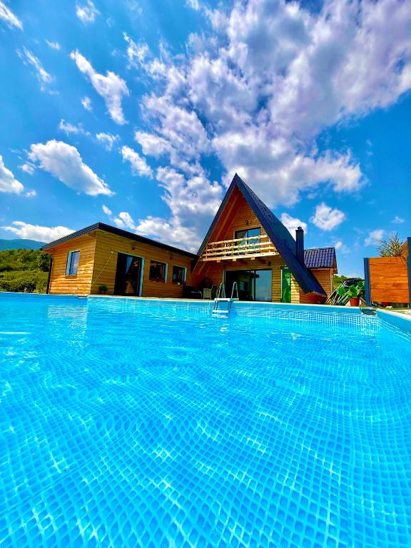 a large swimming pool in front of a house at Kuća za odmor Villa Kovačević in Bihać