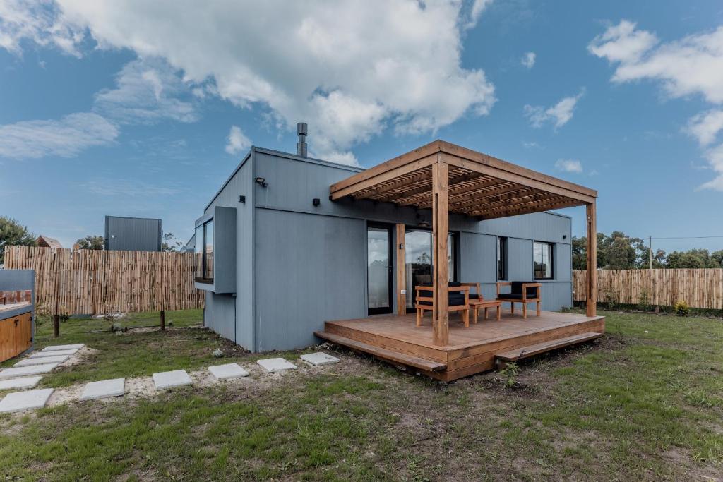 Colonia ChapadmalalDread Shack Nodo Norte 2 - Casa en Complejo Zona Santa Isabel, Chapa Para 4 PAX Con Parrilla - Hola Sur的一栋带木制露台和屋顶的小房子