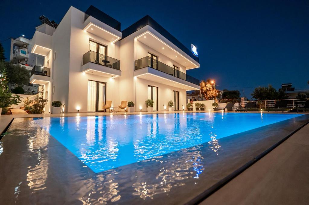 a villa with a swimming pool at night at Crystal 13 Villas in Ksamil