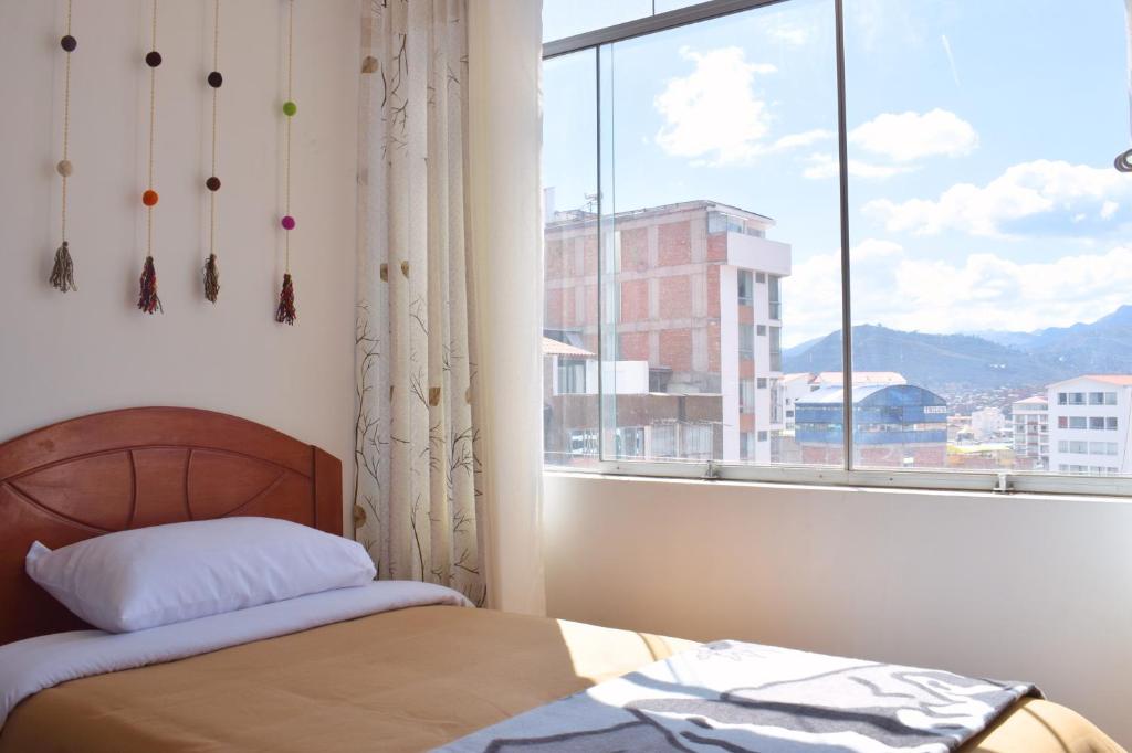 Giường trong phòng chung tại Qosqo Tampu Apart Hotel