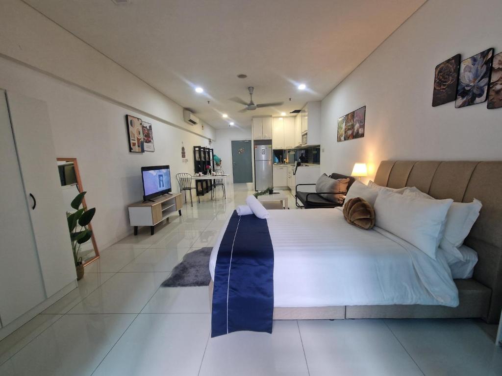 a bedroom with a large bed and a living room at Summer suites Klcc 8 min walk Free Netflix and WiFi by AA GLOBAL in Kuala Lumpur