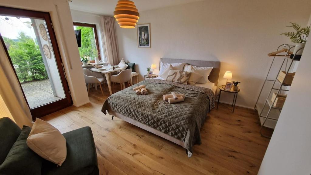 a bedroom with a bed with two teddy bears on it at Cozy Schwarzwaldnest für 2! in Schönwald