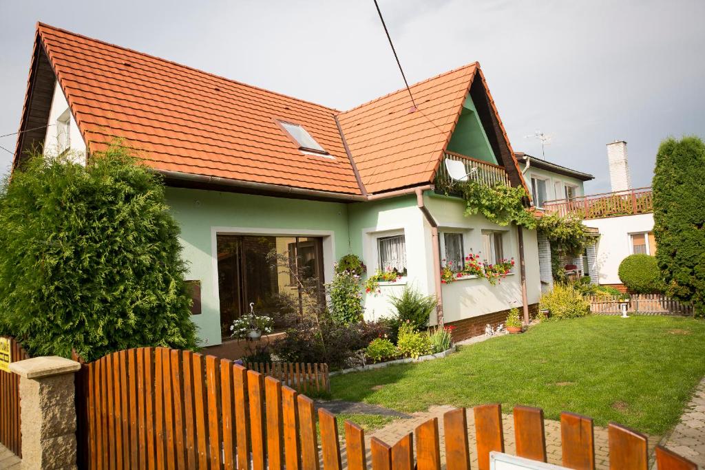 a house with an orange roof and a fence at Ubytovanie na súkromí in Turčianske Teplice