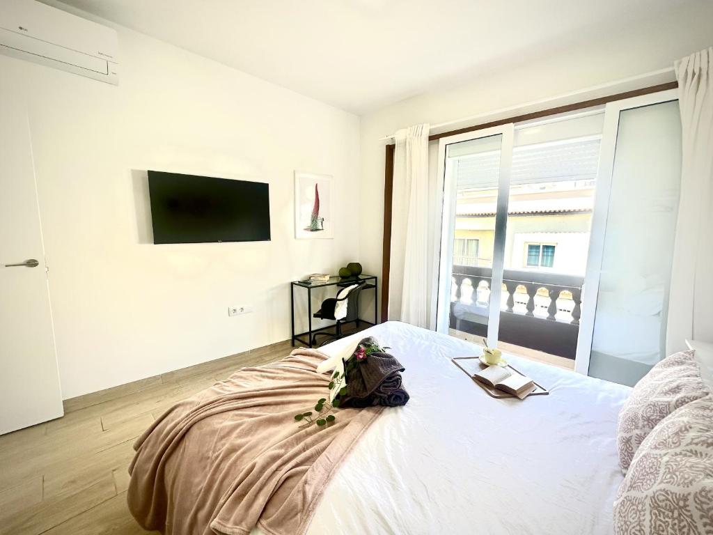 a white bedroom with a bed and a large window at Vilaflor Suit Dreams by Deihu Experiences in Vilaflor
