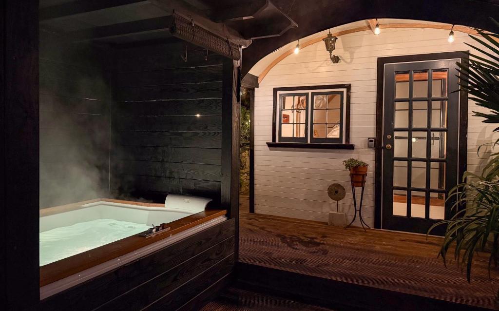 a bathroom with a bath tub with smoke in it at The Cabana Luxury Award Winning Tiny Home with Hot Tub and Private Garden 2 mins Walk to Ryde Beach in Ryde