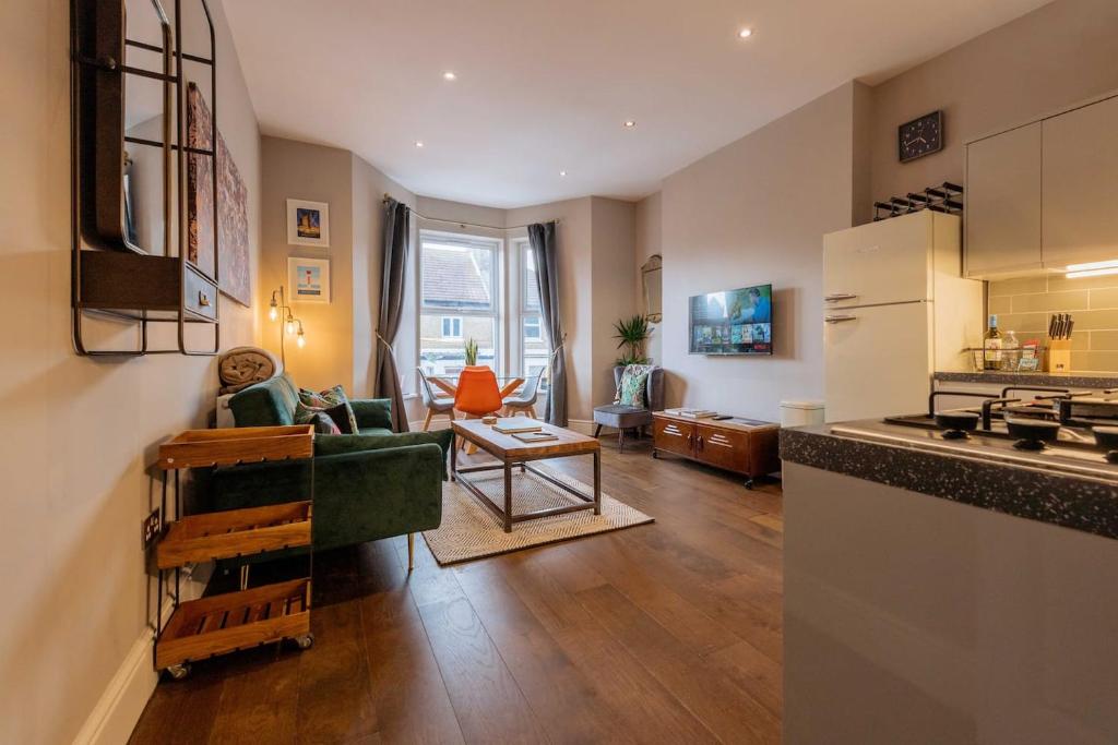 a living room with a couch and a kitchen at Sandy Bay - Mins To Margate Main Sands in Margate