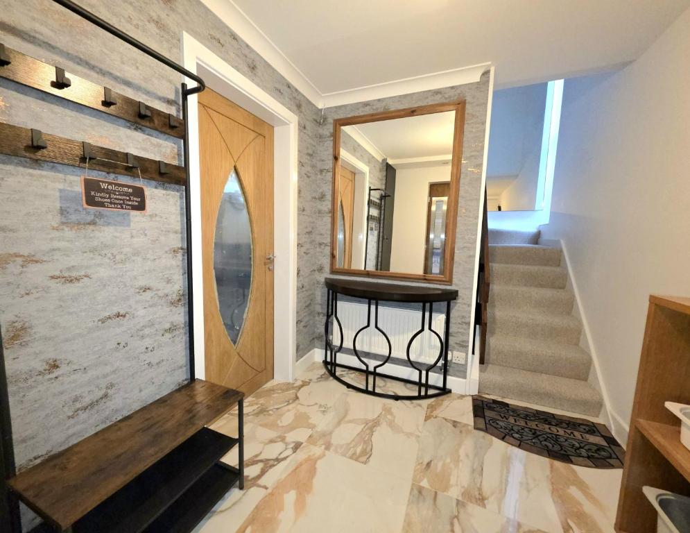 a hallway with a staircase and a mirror at Wembley Park prime location for Stadium events City break in London