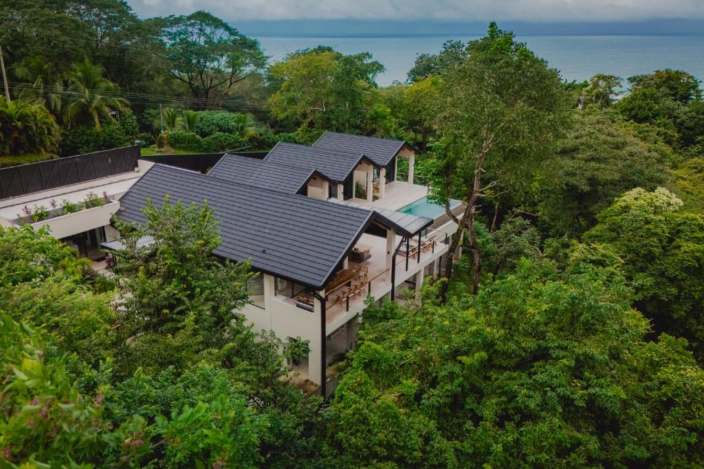 an aerial view of a house in the trees at Villa Bahia Oceanview Designer Retreat Malpais in Mal País