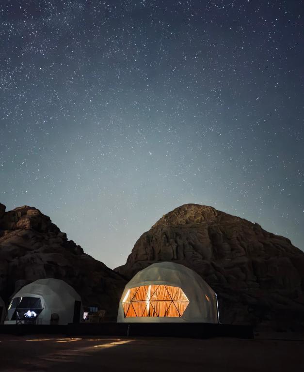 two domes in the desert under a starry sky at Wadi rum sky luxury in Disah