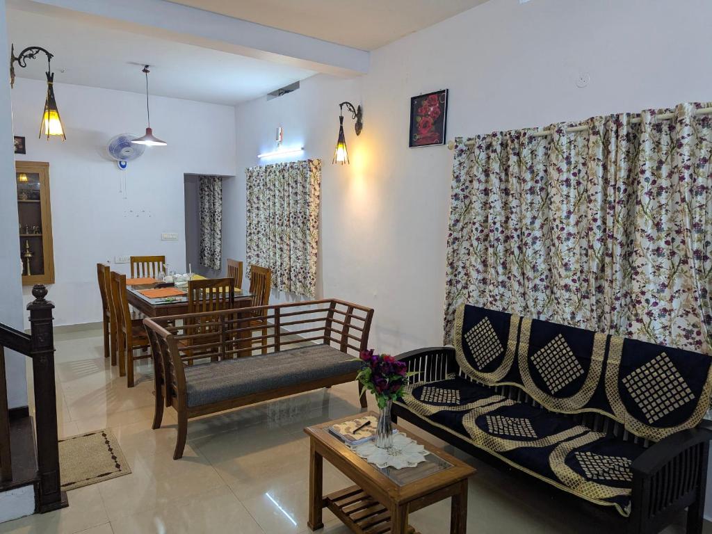 a living room with a couch and a table at Sankeerthanam - Lounge in serenity in Cochin