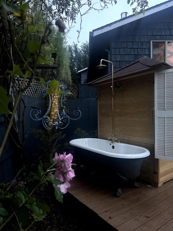 a bath tub sitting on a wooden deck at Sal's Beach Cottage Retreat in Fort Bragg