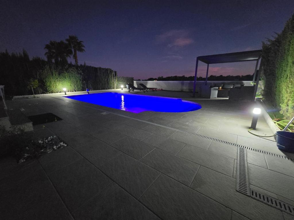 a swimming pool in a yard at night at Villa exceptionnelle avec piscine privée et terrasse in Villamartin