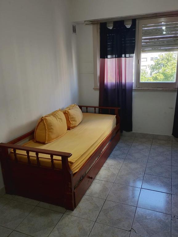 a bed with two pillows on it in a room at Departamento Casino in Mar del Plata