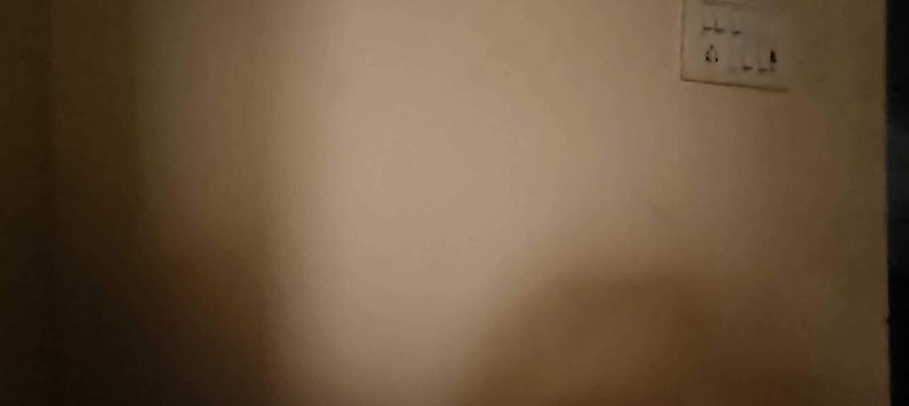 una pared blanca con enchufe en Hotel O DP Palace, en LKO