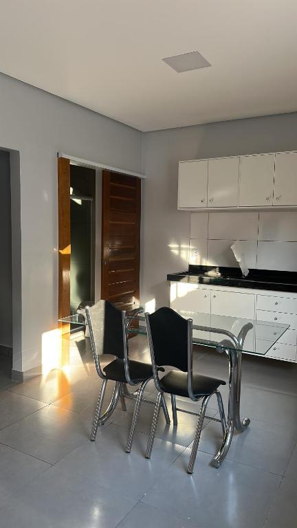 a kitchen with a table and chairs in a room at Apto Completo - 100m da Av Weyne Cavalcante, Centr in Canaã dos Carajás