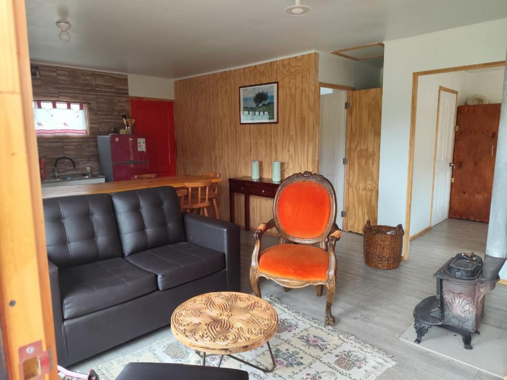a living room with a couch and a chair at Cabaña Campestre in El Cerrillo