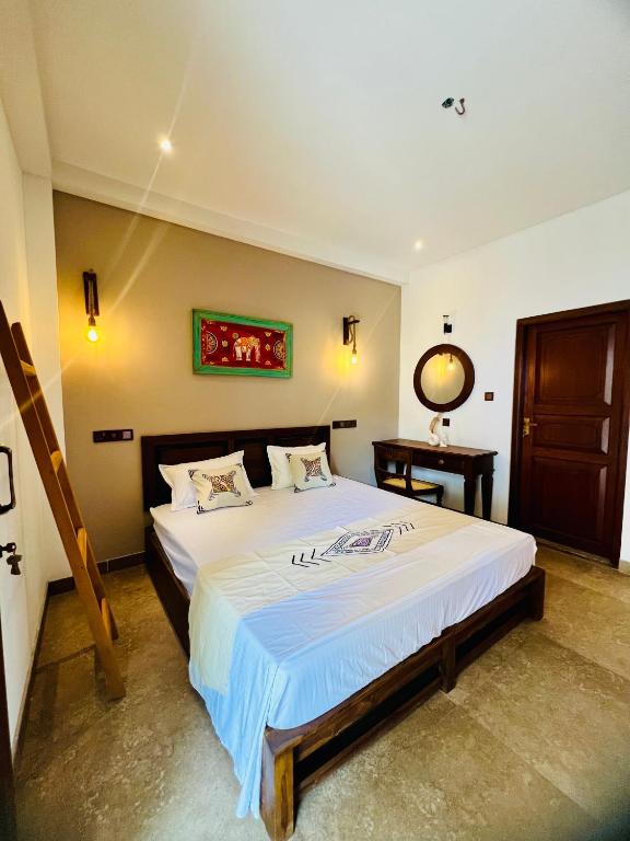 a bedroom with a large bed in a room at VOGEL NEST in Midigama East