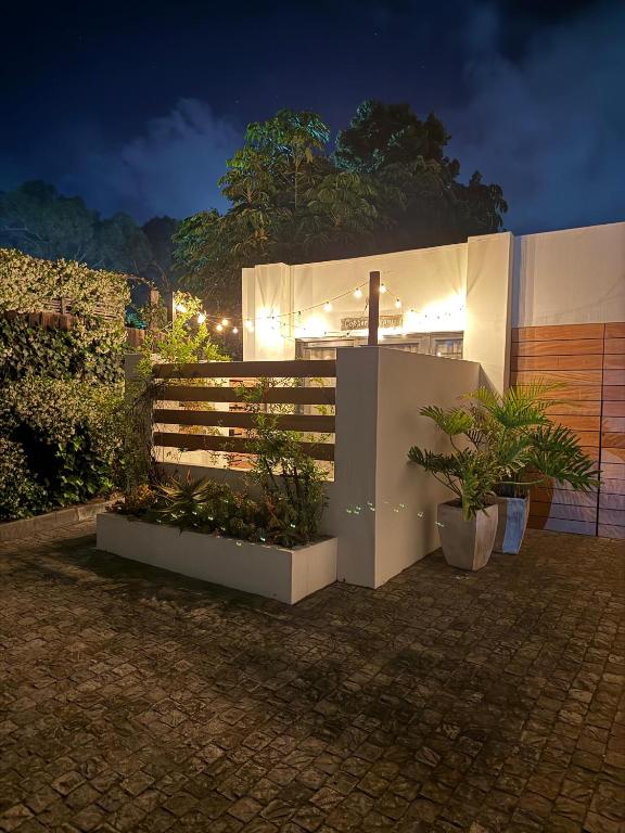 a house with plants and a fence at night at RElaxed city living in Port Elizabeth