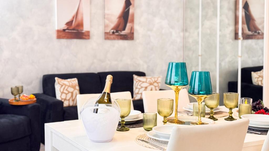 a dining table with a bottle of wine and glasses at Lady Teresa 2-0 by Ca-Sa Check in Chioggia