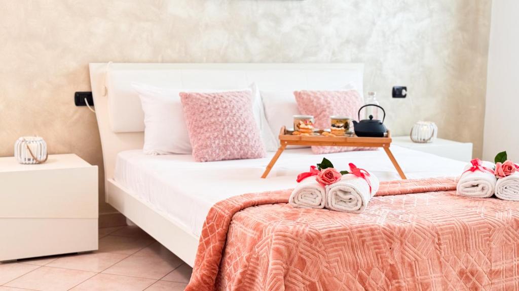 a bedroom with two beds and a table with towels at Lady Teresa 2.0 by Ca-Sa Check in Chioggia