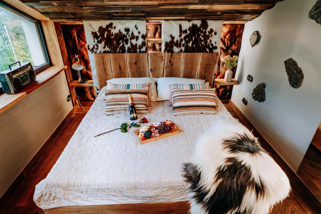 a bedroom with a bed with a tray of food on it at StyLove-Apartamenty in Ustroń