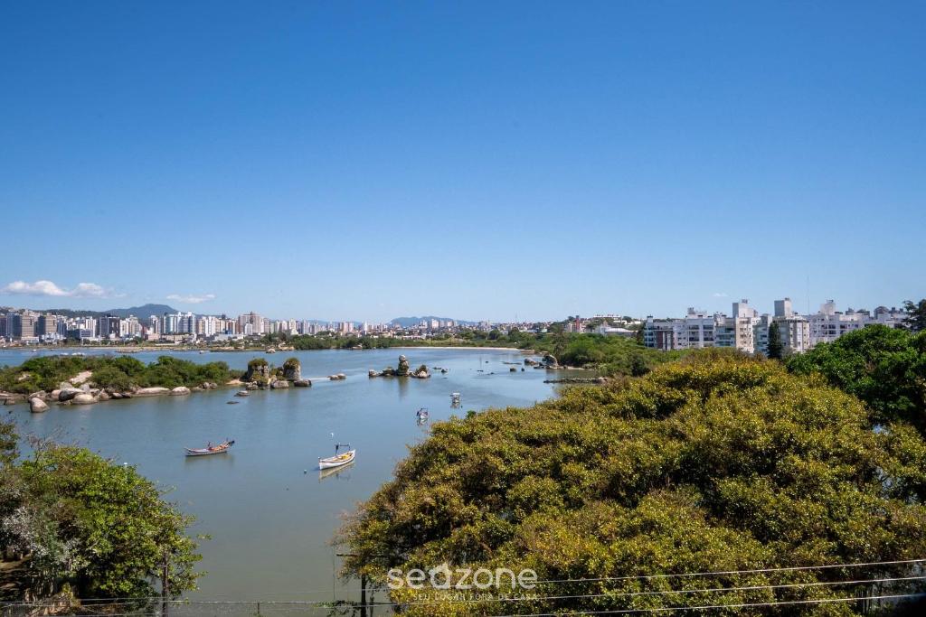 a river with boats on it with a city in the background at Apt 2 Bedrooms w/ Air in Floripa CIS0033 in Florianópolis
