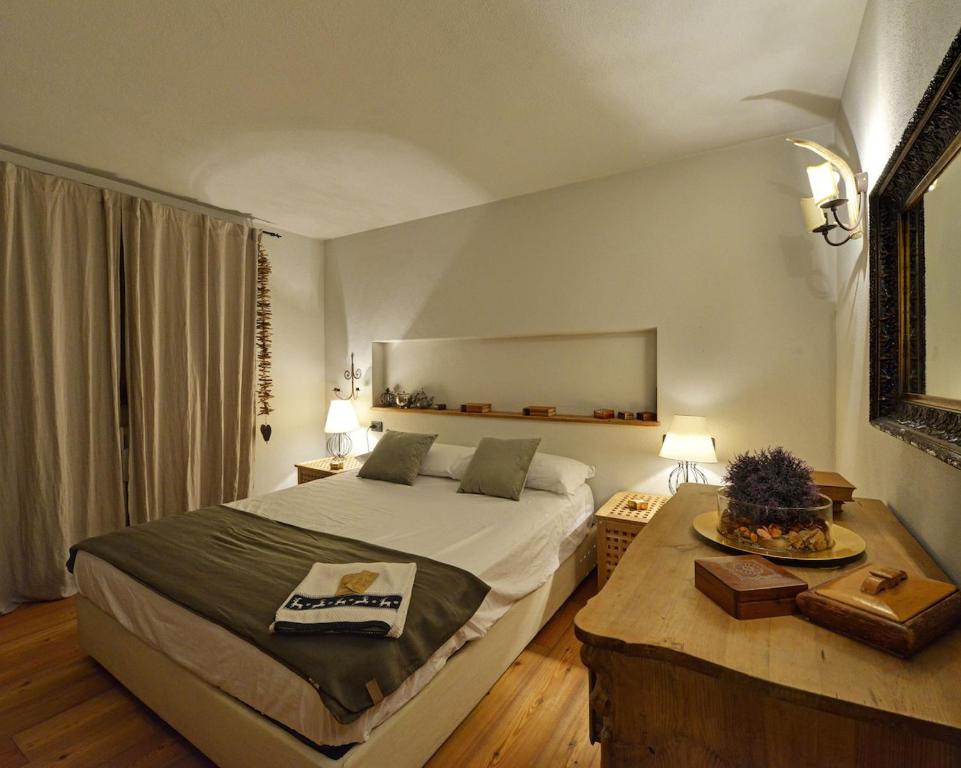 En eller flere senge i et værelse på Courmaison - Appartamento di charme