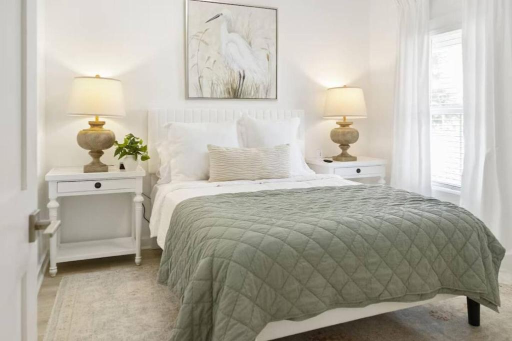 a bedroom with a bed with two night stands and two lamps at Weekend Escape on the Coast-Relax & Unwind in Pass Christian
