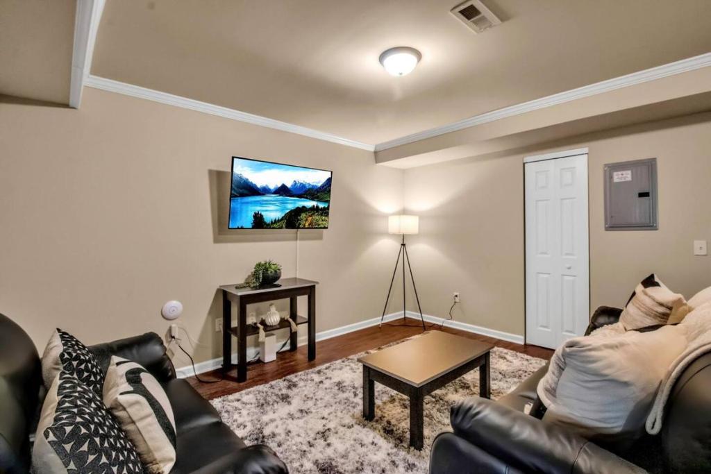 a living room with a couch and a table at Spacious 3 bed 3 bath Apartment No stairs in Buffalo