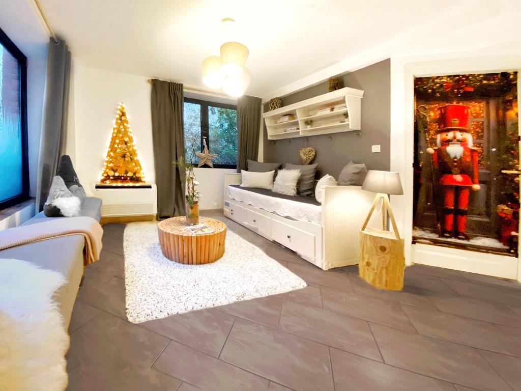 a living room with a christmas tree and a bed at Deluxe - Le millésime - Calme in Strasbourg