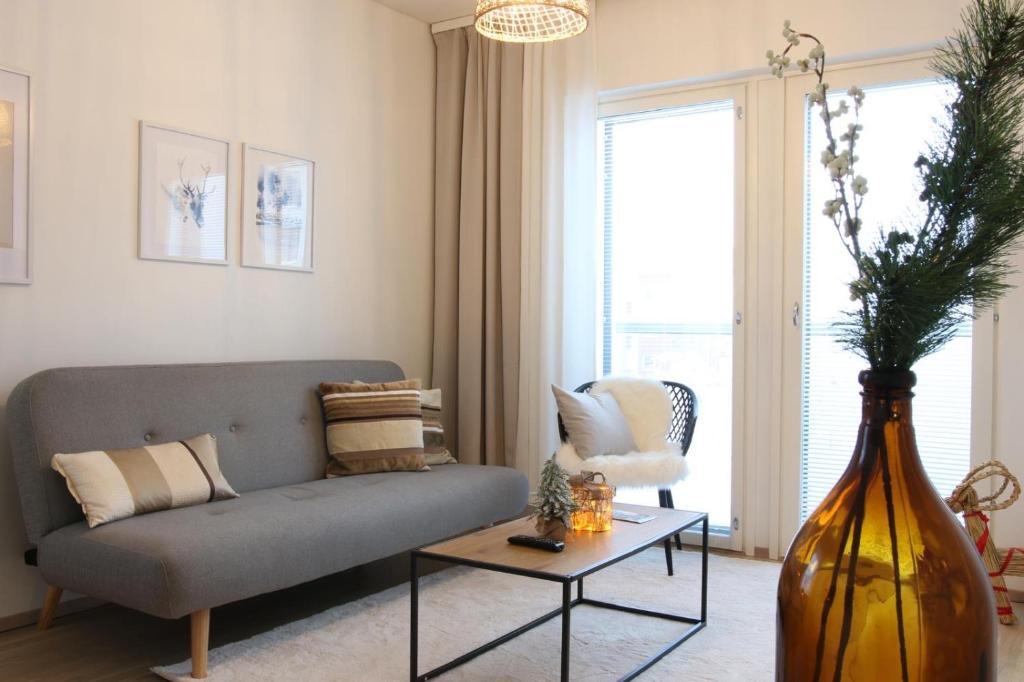 a living room with a couch and a table at Arctic Aurora Suite Rovaniemi in Rovaniemi