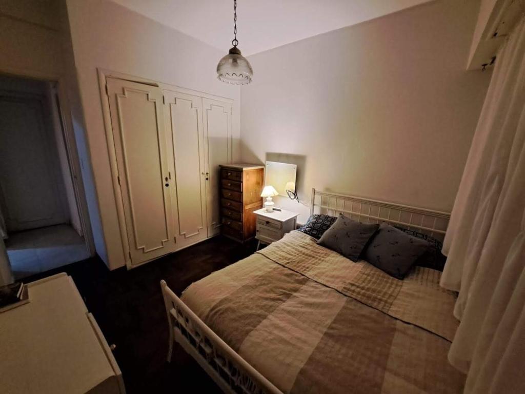 a bedroom with a large bed and a dresser at Departamento 3 Ambientes Plaza Colon in Mar del Plata