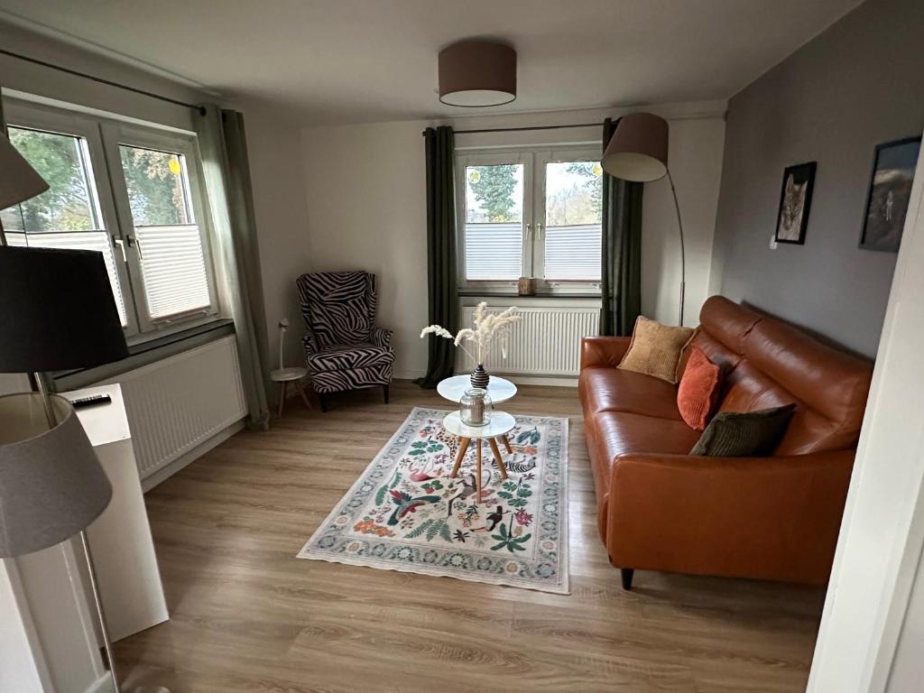 a living room with a couch and a table at Huck’s Ferienhäuser in Borstel