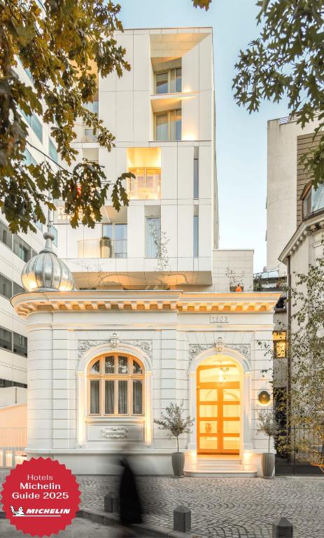 a white building with a yellow door in front of it at ROSETTI Hotel in Bucharest