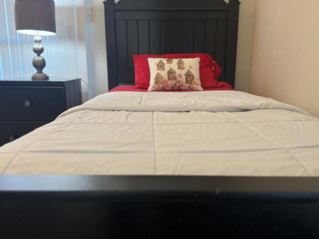 un letto con testiera nera e cuscino rosso di Private First-Floor Guest Suite with 2BR 1Bath full Kitchen a Tracy