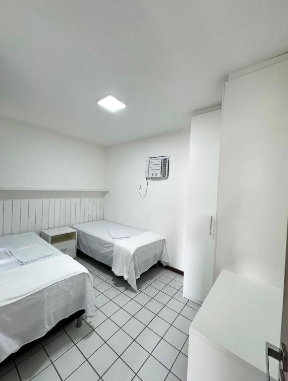 a hospital room with two beds and a fan at Edifício Atlantis Hotel in Maceió