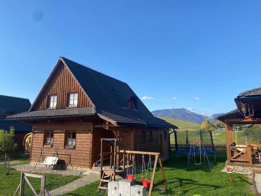 利普托斯基米库拉斯Liptovské Drevenice-chaty的木屋前方设有游乐场