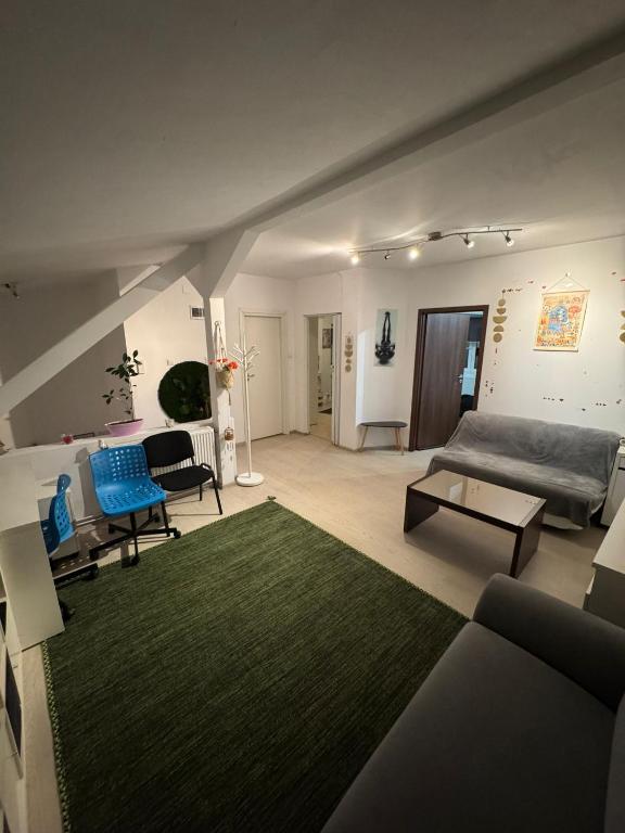 a living room with a couch and a green rug at Bucharest Residence in Bucharest