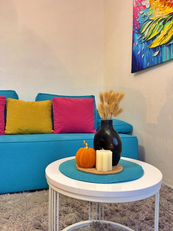 a table with a vase and pumpkins on it at Sarajevo Main Street Residence in Sarajevo