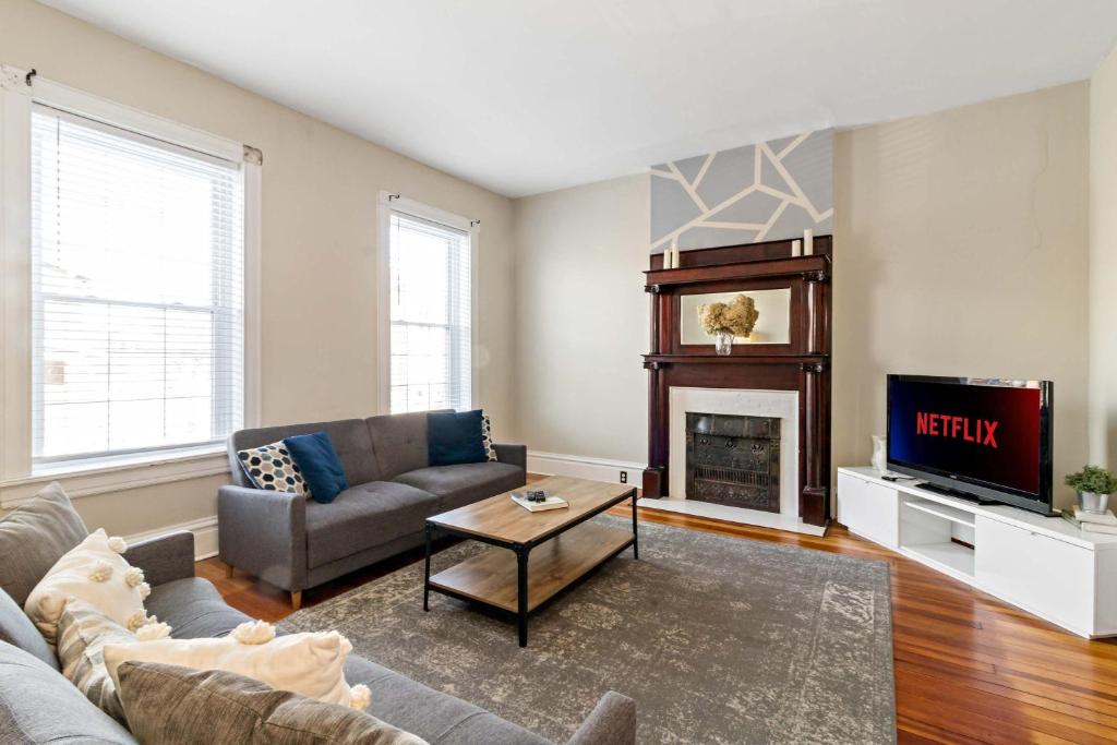 a living room with a couch and a tv at Pet-Friendly Benton Park 1BR Apt with Private Backyard in Soulard