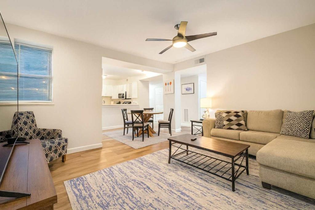 a living room with a couch and a table at 2BR w King Bed Pool Steps to Forest Park CWE in Tower Grove