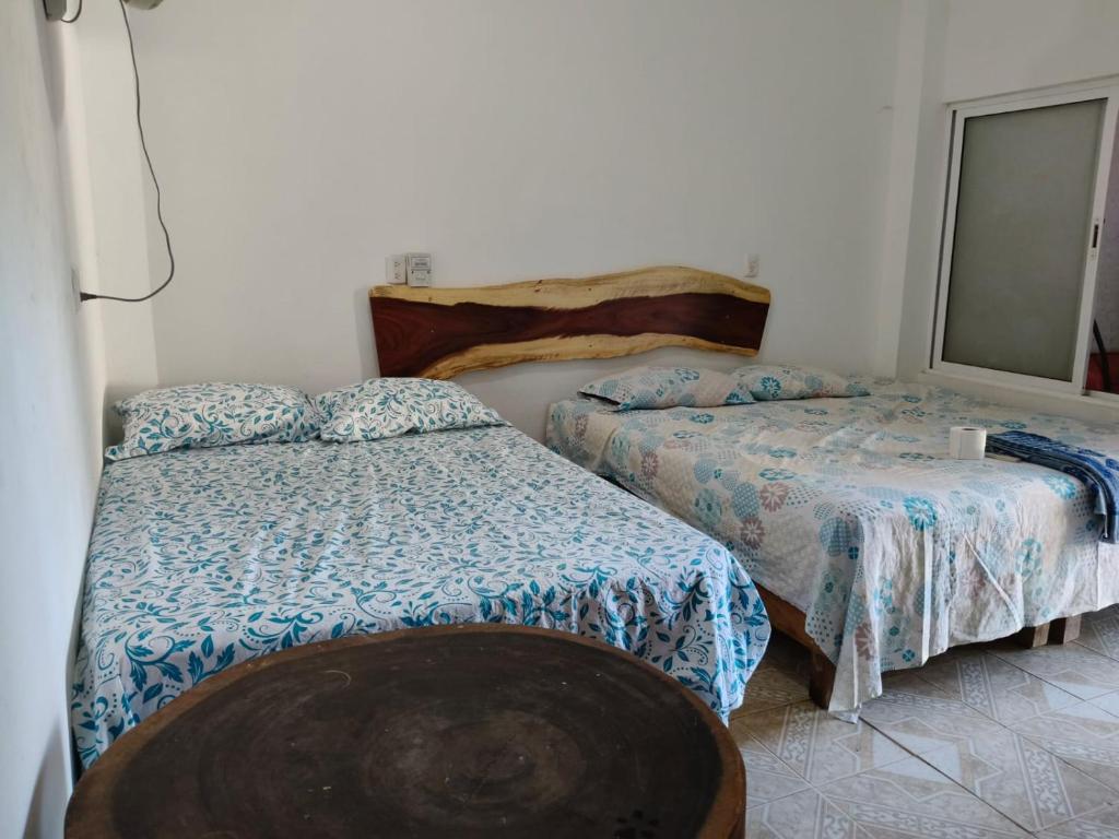 Ein Bett oder Betten in einem Zimmer der Unterkunft Fiesta Zipolite