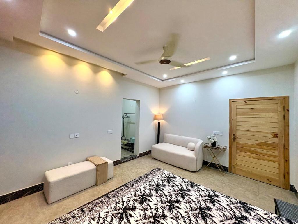 a living room with a couch and a table at 1 - bedroom near Lyallpur galleria in Faisalabad