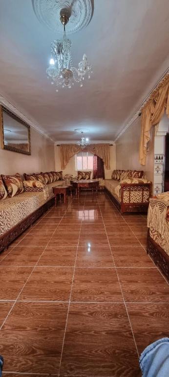 a living room with couches and a chandelier at serenity house 